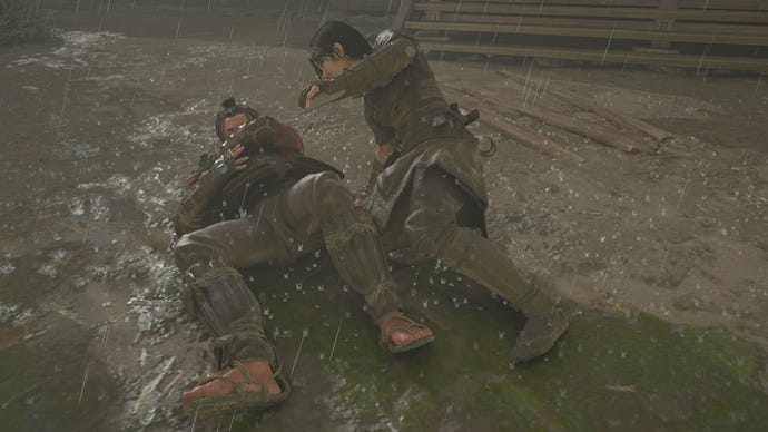 Naoe leans over a fallen opponent after stabbing him with her hidden blade in Assassin's Creed Shadows.