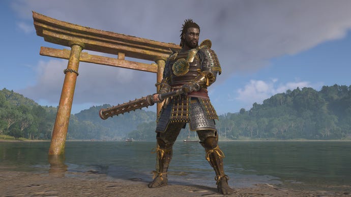 Yasuke stands strong with his kanebo in Assassin's Creed Shadows, in front of a torii gate.