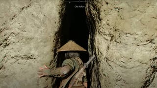 Naoe stands in front of a giant rift in a rock wall that leads to the Old Kofun in Assassin's Creed Shadows.